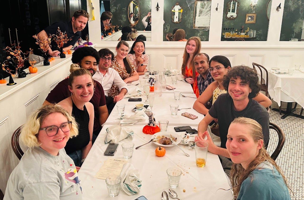 The lab gathered around a long dinner table at the 14-year lab-iversary retreat in New Orleans.
